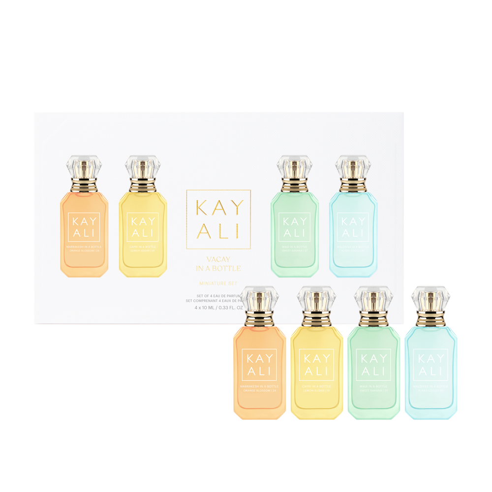 Set of eight Kayali perfume bottles in various pastel colors on a white background.
